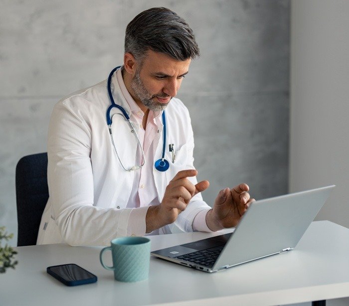 doctor offering support or medical advice to a patient during online medical appointment consultation